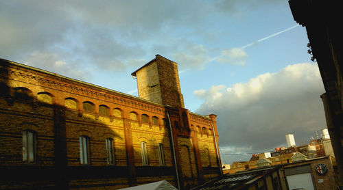 Low angle view of historical building against cloudy sky