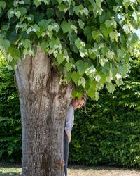 Rear view of woman standing amidst plants