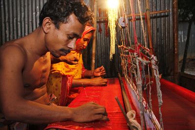 Husband and wife weave loom sarees together