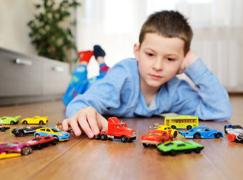 Boy playing with toy car at home