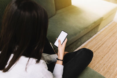 Rear view of woman using mobile phone