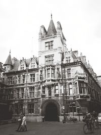 Woman in front of building against sky