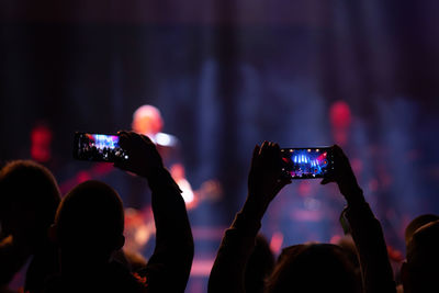 People photographing at music concert