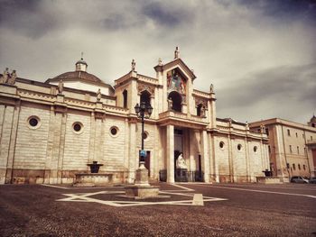 Building exterior against cloudy sky