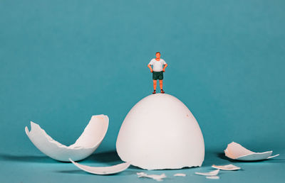 White figurine against blue background