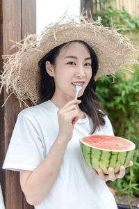 Portrait of young woman drinking coffee