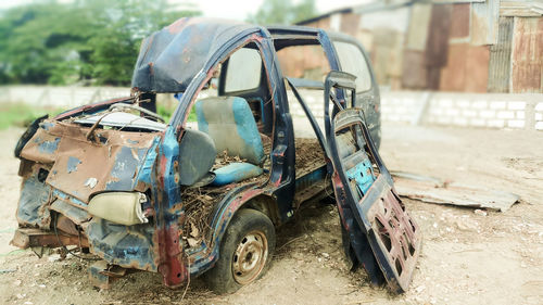 Abandoned vintage car on field