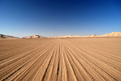 Tire track on sand in desert