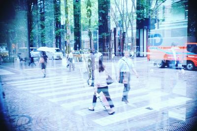 People walking on road in rain