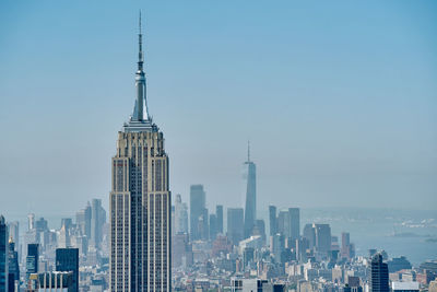 Modern buildings in city against clear sky