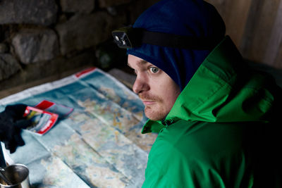 Man looking away against map