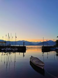 Boats in marina at sunset