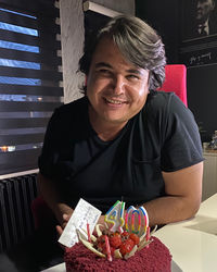 Portrait of smiling man sitting at home