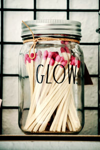 Close-up of text in glass jar on table