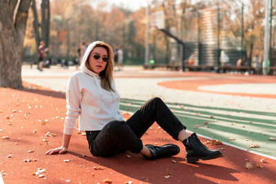 Portrait of young woman sitting outdoors