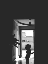 Boy standing by window at home
