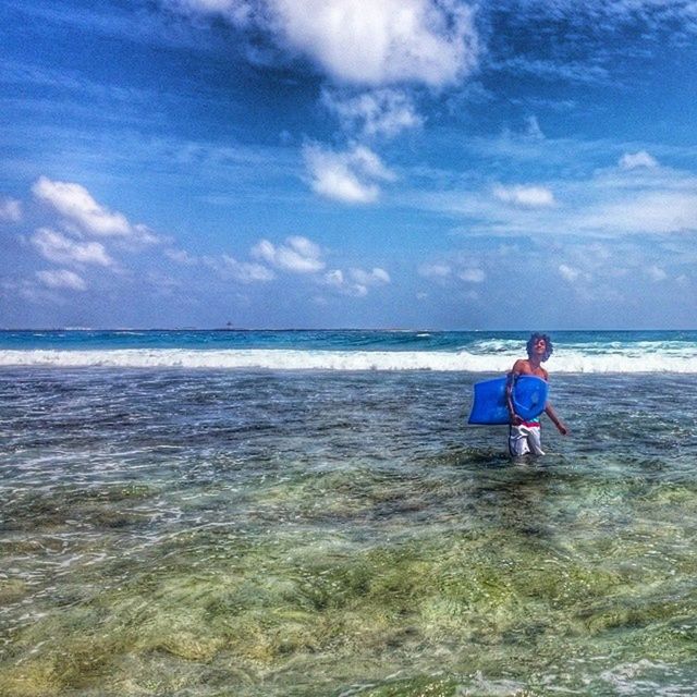 water, sea, leisure activity, horizon over water, lifestyles, sky, full length, beach, childhood, casual clothing, boys, elementary age, rear view, vacations, shore, person, beauty in nature