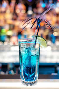 Close-up of azure lemonade cocktail on bar counter