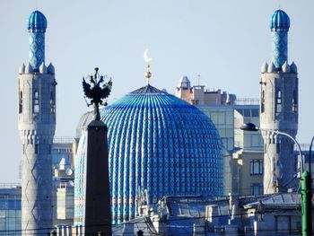 Skyscrapers in city against blue sky