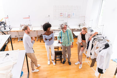 Portrait of fashion designers standing at boutique