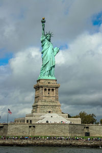 Statue of liberty against cloudy sky