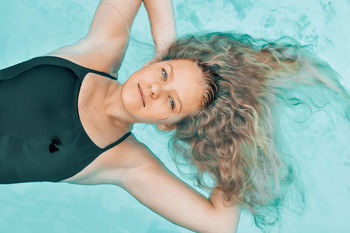 High angle portrait of young woman in swimming pool