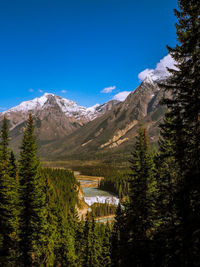 Scenic view of mountains against blue sky