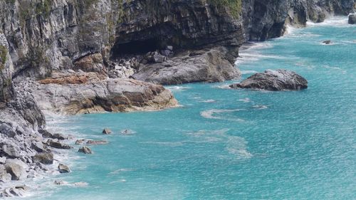 Scenic view of sea by cliff