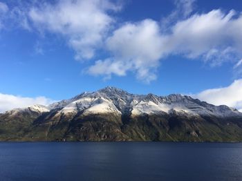 Scenic view of sea and mountains against sky