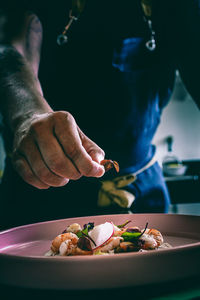 Close-up of man preparing food