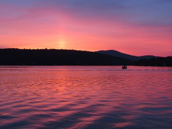 Scenic view of lake against romantic sky at sunset