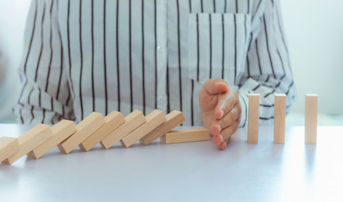 Midsection of man playing with wooden blocks