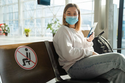 Man using laptop while sitting on sofa at home