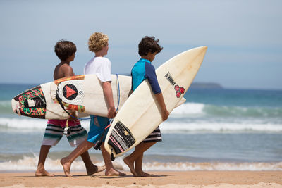 Rear view of people on beach