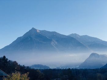 Scenic view of mountains against clear blue sky