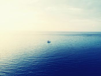 Sailboat sailing on sea against sky