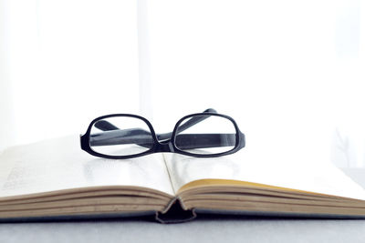 Close-up of eyeglasses on book