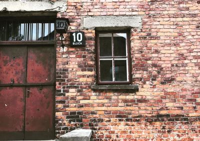 Low angle view of window on brick wall of building