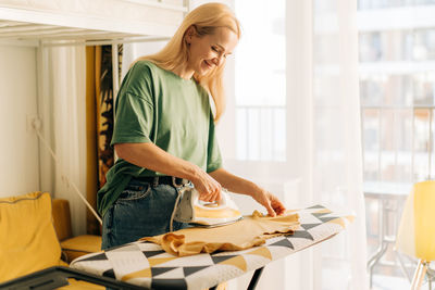 Side view of young woman working at home