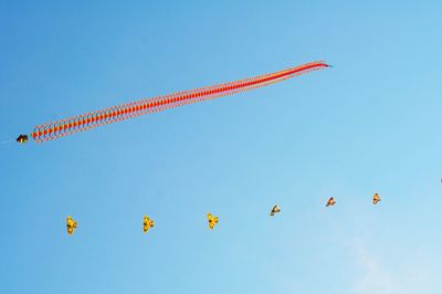 Low angle view of airshow against clear sky