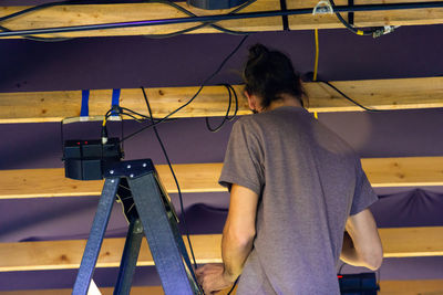 Rear view of woman standing on stage