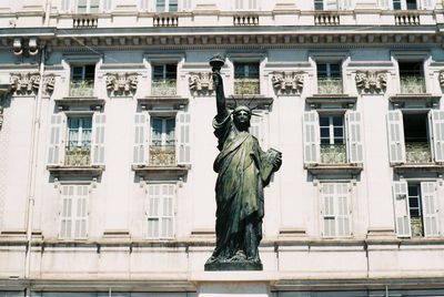 Low angle view of statue against building