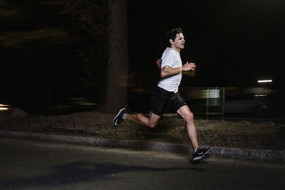 Full length of man running in city at night