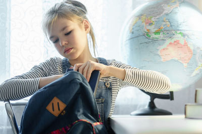 Girl looking away while sitting at home