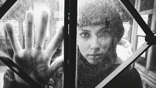 Portrait of man looking through window