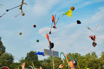 Low angle view of balloons flying against sky