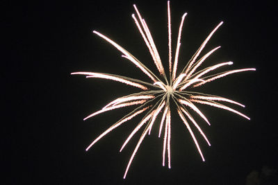 Low angle view of firework display at night