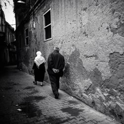 Rear view of people walking on street