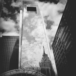 Low angle view of buildings against cloudy sky