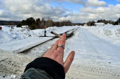 Midsection of person on snow against sky